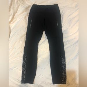 Black Lululemon leggings.  Reflective Rose embroidery and zippered pockets